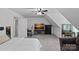 Comfortable bedroom with angled ceilings, dresser, work area, and ceiling fan at 3124 Lakewood Edge Dr, Charlotte, NC 28269