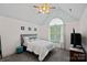 A bedroom with a high ceiling, ceiling fan, carpet, large window, and neutral walls at 3124 Lakewood Edge Dr, Charlotte, NC 28269