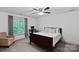 Bright carpeted bedroom with large window, desk, and stylish furnishings at 3124 Lakewood Edge Dr, Charlotte, NC 28269