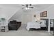 Cozy carpeted bedroom featuring ceiling fan, seating area, and comfortable bed at 3124 Lakewood Edge Dr, Charlotte, NC 28269