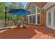 Backyard deck features outdoor seating area with umbrella and a view of the yard at 3124 Lakewood Edge Dr, Charlotte, NC 28269