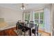 Bright dining room with hardwood floors, large windows, and a modern dining set at 3124 Lakewood Edge Dr, Charlotte, NC 28269