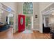 Bright foyer featuring a grand, high window over a red front door and hardwood floors at 3124 Lakewood Edge Dr, Charlotte, NC 28269