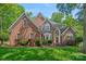 Stunning brick home featuring lush landscaping and a meticulously manicured lawn at 3124 Lakewood Edge Dr, Charlotte, NC 28269