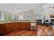 An open-concept kitchen with wooden cabinets, granite countertops, stainless steel appliances, and hardwood floors at 3124 Lakewood Edge Dr, Charlotte, NC 28269