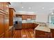 A kitchen with wooden cabinets, granite countertops, stainless steel appliances, and hardwood floors at 3124 Lakewood Edge Dr, Charlotte, NC 28269