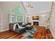Spacious living room with hardwood floors, fireplace, and large windows, and modern furnishings at 3124 Lakewood Edge Dr, Charlotte, NC 28269