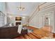 Open living space with hardwood floors, fireplace, and staircase in a modern setting at 3124 Lakewood Edge Dr, Charlotte, NC 28269