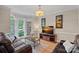 Cozy sitting room featuring bay windows, hardwood floors, and an entertainment center at 3124 Lakewood Edge Dr, Charlotte, NC 28269