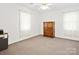 Cozy bedroom with neutral carpeting, bright windows, and a classic wood dresser for ample storage at 3164 Devonshire Dr, Rock Hill, SC 29732