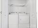 Washer and dryer nestled in laundry room with storage at 3164 Devonshire Dr, Rock Hill, SC 29732