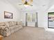 Spacious living room featuring plush carpeting, a ceiling fan, and tasteful decor creating a cozy atmosphere at 3164 Devonshire Dr, Rock Hill, SC 29732