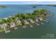 Aerial view of waterfront homes with private docks and lush landscaping along the lake at 3507 Governors Island Dr, Denver, NC 28037