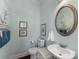 Coastal-themed powder room with a white vanity, stylish decor, and charming nautical accents at 3507 Governors Island Dr, Denver, NC 28037