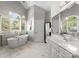 Bright bathroom featuring marble floors, double vanity, and an alcove soaking tub at 3507 Governors Island Dr, Denver, NC 28037