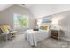 Cozy bedroom featuring a comfortable bed, rocking chair and natural light at 3507 Governors Island Dr, Denver, NC 28037
