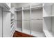 Walk-in closet featuring white shelves and wooden floors at 3507 Governors Island Dr, Denver, NC 28037