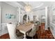 Elegant dining room with columns, hardwood floors, and stylish chandelier at 3507 Governors Island Dr, Denver, NC 28037