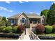 Brick home with steps leading to a private dock and waterfront at 3507 Governors Island Dr, Denver, NC 28037