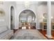 Elegant foyer with high archways, hardwood floors, and stylish chandelier at 3507 Governors Island Dr, Denver, NC 28037