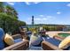 Enjoy waterfront views from this outdoor seating area featuring comfortable wicker furniture and a serene ambiance at 3507 Governors Island Dr, Denver, NC 28037