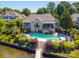 A waterfront home features a lovely backyard pool and outdoor seating with waterfront views at 3507 Governors Island Dr, Denver, NC 28037