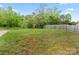 Spacious backyard with green lawn, wooden fence, and mature trees offers privacy and potential for outdoor activities at 355 Jared Steel Ln, Salisbury, NC 28146
