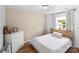 Neutral bedroom featuring hardwood floors, white dresser and a queen bed next to a window with white curtains at 355 Jared Steel Ln, Salisbury, NC 28146