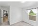 Bright bedroom with neutral carpet, a large window, and access to the kitchen at 355 Jared Steel Ln, Salisbury, NC 28146