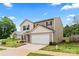 Two-story home with beige siding, white garage door, and red shutters sits under a blue sky at 355 Jared Steel Ln, Salisbury, NC 28146