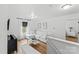 Bright living room with white walls, wood floors, and a large sectional sofa near a window at 355 Jared Steel Ln, Salisbury, NC 28146