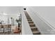 Carpeted staircase leads to the upper level, next to an open-concept kitchen and living area at 355 Jared Steel Ln, Salisbury, NC 28146
