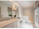 Bright bathroom features a glass-enclosed shower and marble countertops, offering a luxurious and spa-like feel at 3950 Abingdon Rd, Charlotte, NC 28211
