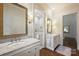 Beautiful bathroom with double vanities, marble countertops, elegant mirrors, and a glass shower at 3950 Abingdon Rd, Charlotte, NC 28211