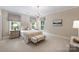Serene bedroom features two large windows, bedside tables, and a cozy bench at 3950 Abingdon Rd, Charlotte, NC 28211
