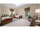 Inviting bedroom features twin beds, neutral decor, and ample natural light from large windows, creating a serene atmosphere at 3950 Abingdon Rd, Charlotte, NC 28211