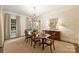 Formal dining room boasting a large table, decorative wallpaper, and elegant chandelier at 3950 Abingdon Rd, Charlotte, NC 28211