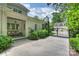 View of the property showing outdoor seating, a gated entrance, and lush, mature landscaping at 3950 Abingdon Rd, Charlotte, NC 28211