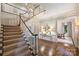 Bright foyer featuring a grand staircase, hardwood floors, and elegant decor at 3950 Abingdon Rd, Charlotte, NC 28211