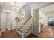 Inviting hallway features hardwood floors, elegant lighting, and access to the kitchen at 3950 Abingdon Rd, Charlotte, NC 28211