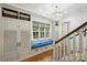 Hallway features a cozy window seat, built-in storage, and natural light at 3950 Abingdon Rd, Charlotte, NC 28211