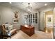 Home office showcasing built-in bookshelves, a large desk, and a comfortable leather chair at 3950 Abingdon Rd, Charlotte, NC 28211