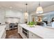 Elegant kitchen featuring a marble island, stainless steel appliances, and open access to the living area at 3950 Abingdon Rd, Charlotte, NC 28211