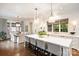 Bright, open kitchen with large island, seating, hardwood floors, and access to dining area at 3950 Abingdon Rd, Charlotte, NC 28211