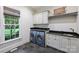 Well-equipped laundry room with modern washer/dryer and ample counter space at 3950 Abingdon Rd, Charlotte, NC 28211