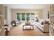 Bright living room features large windows, neutral decor, and a jute rug at 3950 Abingdon Rd, Charlotte, NC 28211