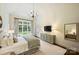 Bright main bedroom with hardwood floors, a king-size bed, chandelier, and natural light from a large window at 3950 Abingdon Rd, Charlotte, NC 28211