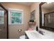 Bathroom with a view to the backyard and a decorative mirror at 4145 Wrangler Sw Dr, Concord, NC 28027
