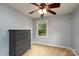 Bedroom with grey dresser, window view at 4145 Wrangler Sw Dr, Concord, NC 28027