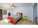 Cozy bedroom with patterned bedding, ceiling fan, and bright green nightstand at 4145 Wrangler Sw Dr, Concord, NC 28027